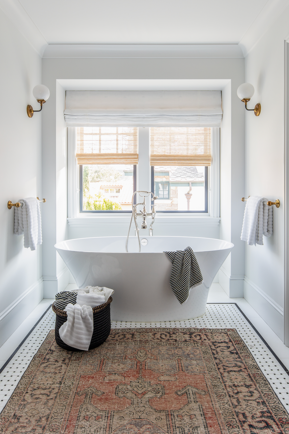 Roman Shades for a Modern Bathroom Aesthetic - a bathroom featuring a freestanding white bathtub and light beige roman shades.