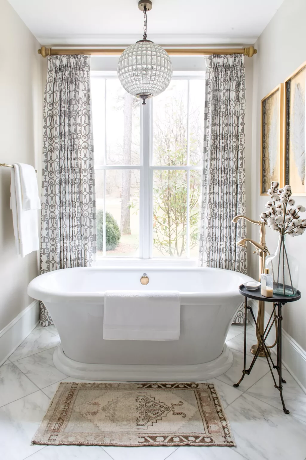 Elegant Drapes with Geometric Patterns for Textured Sophistication - a bathroom adorned with drapes and chandelier lighting.