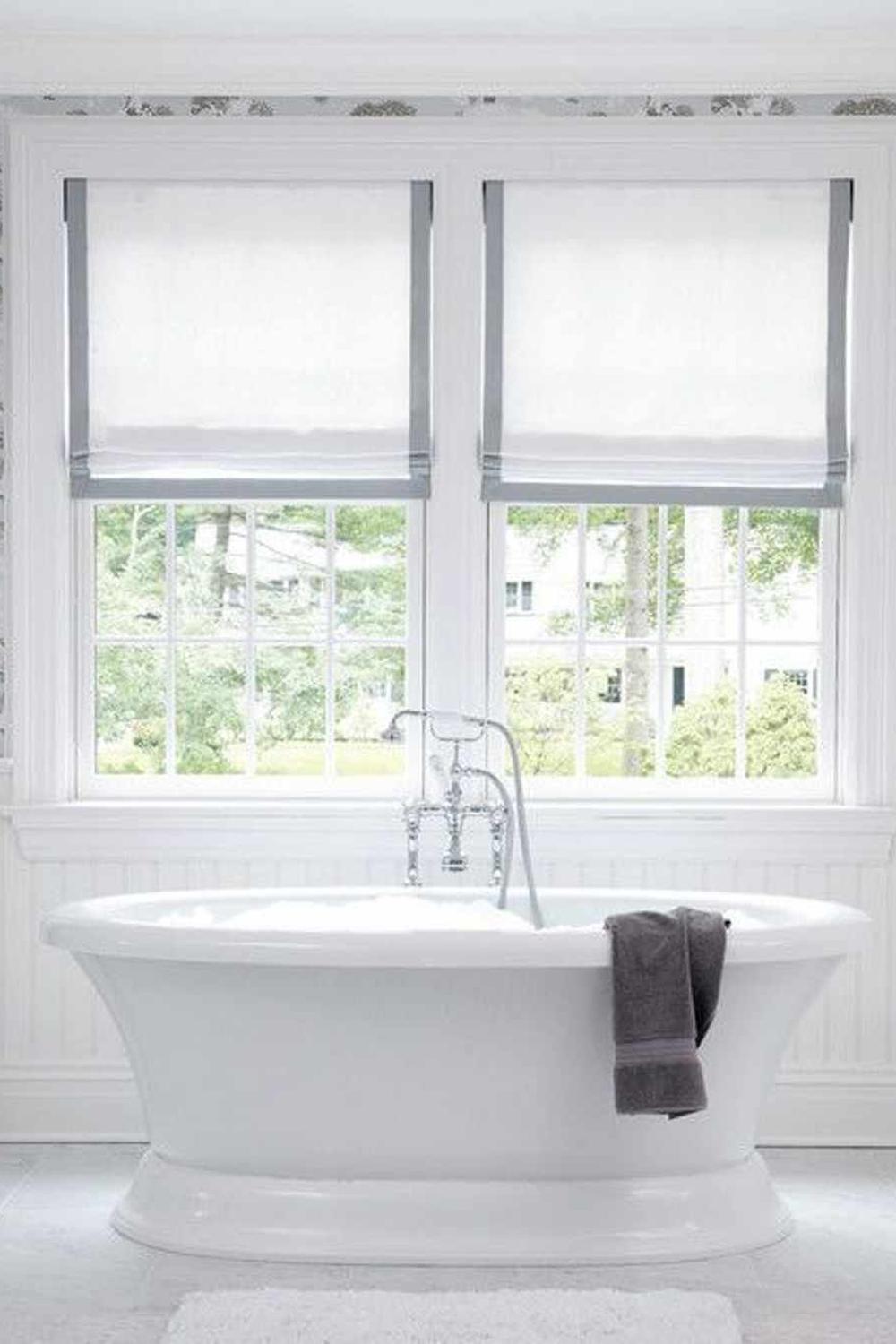 Translucent Roller Shades for Contemporary Minimalism - a bathroom showcasing sheer white roller shades and a freestanding tub.