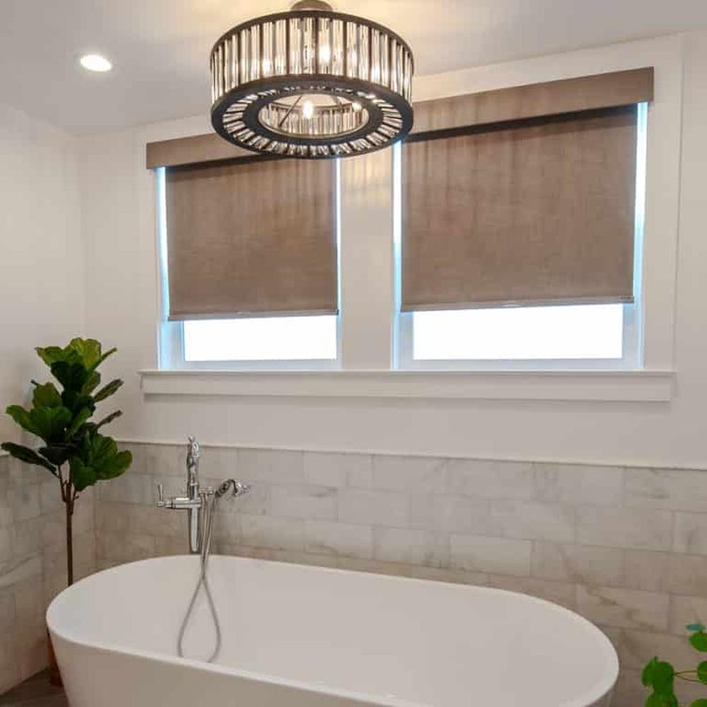 Chic Brown Roller Shades for a Cozy Retreat - a bathroom featuring brown roller shades and potted plants.