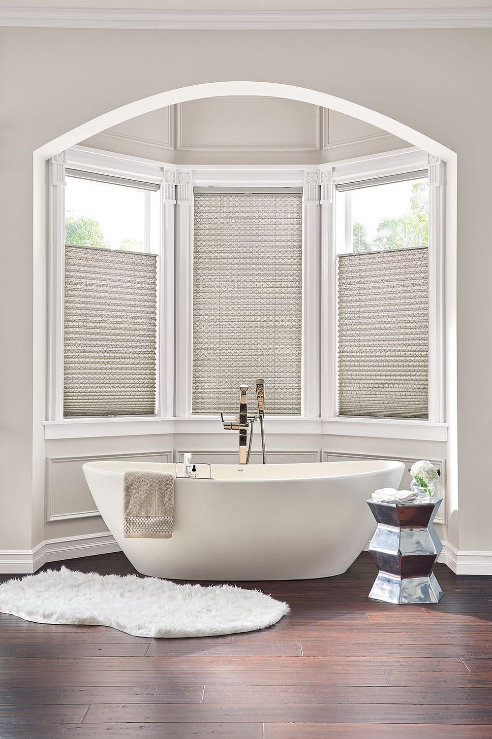 Modern Roman Shades for Vintage Aesthetic - a bathroom with large windows and light woven shades.
