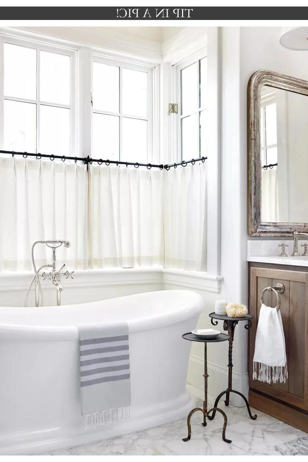 Sleek Sheer Curtains for Bright Ambiance - a bathroom with sheer white curtains and modern fixtures.