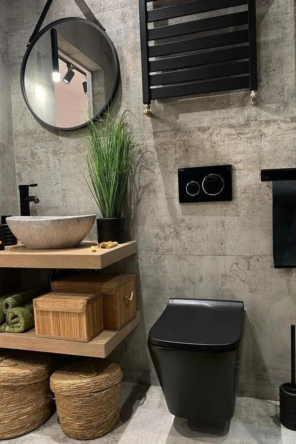 A contemporary bathroom showcasing a black toilet and freestanding tub.