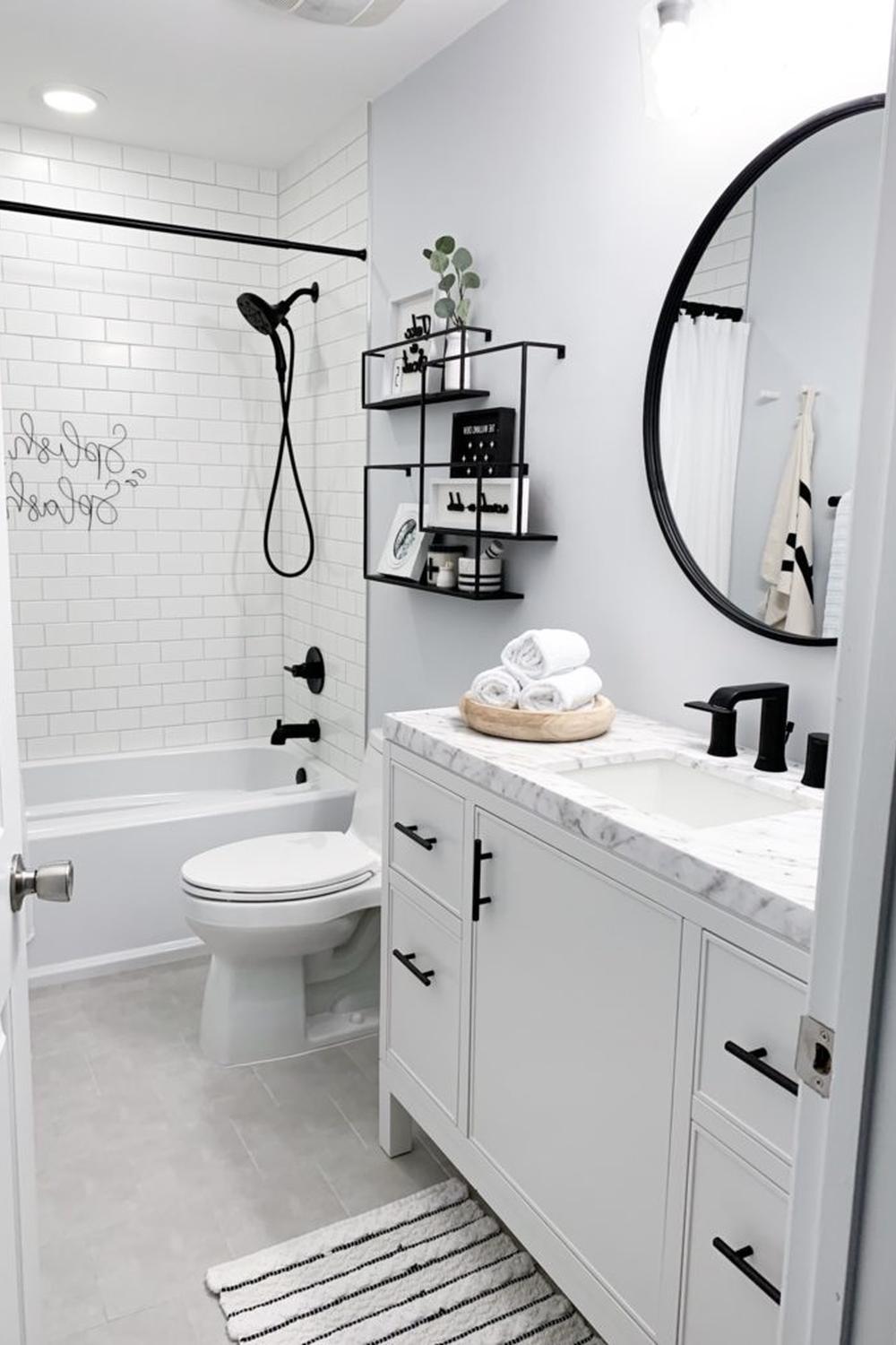 A contemporary bathroom with a streamlined design featuring black fixtures and a light color palette.