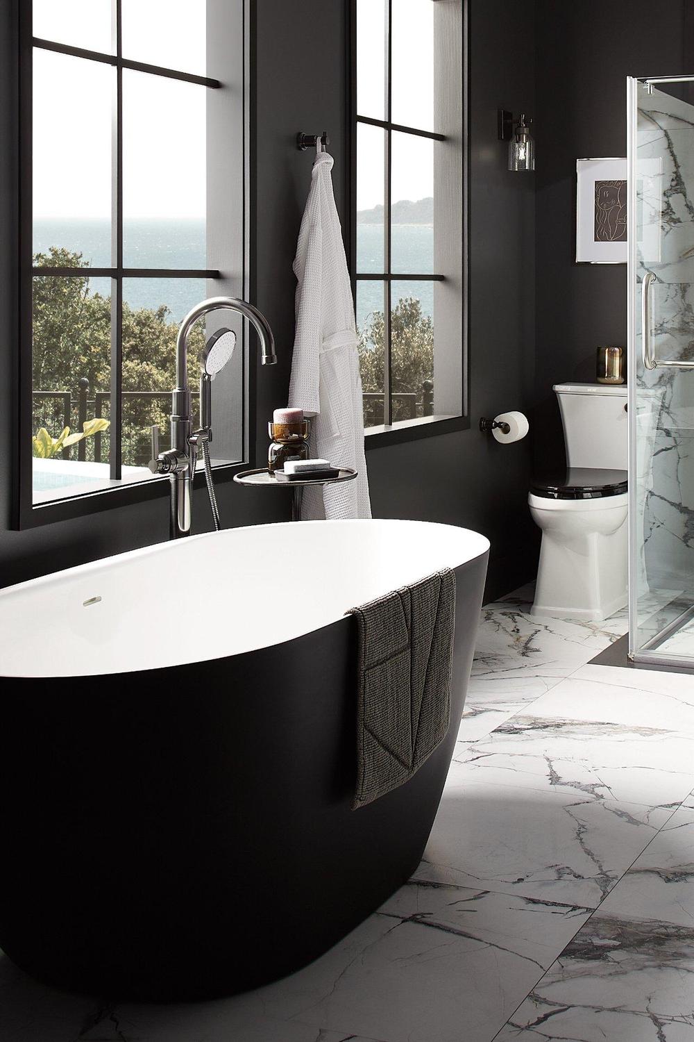A stylish bathroom showcasing a freestanding black bathtub and modern fixtures.
