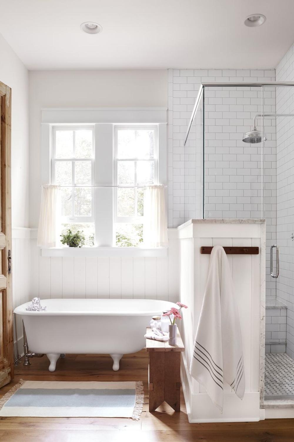Cozy bathroom design featuring shiplap and subway tiles, with natural light streaming in.