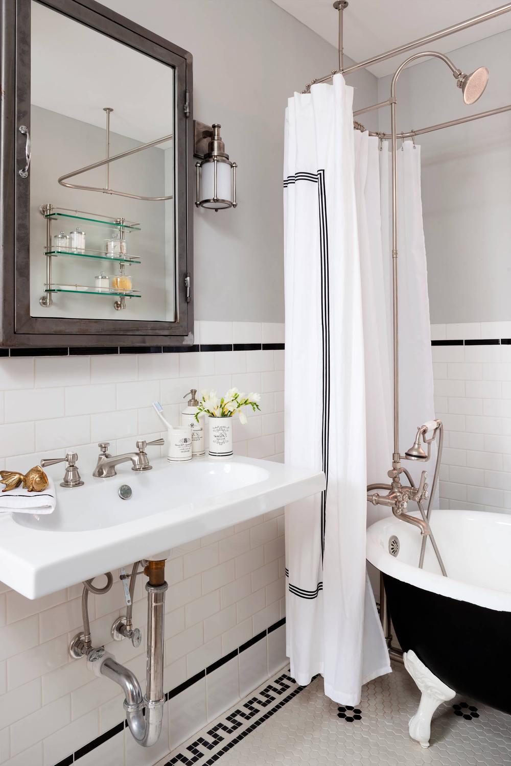 Stylish bathroom featuring a vintage focus with contemporary lightings and bathroom essentials.