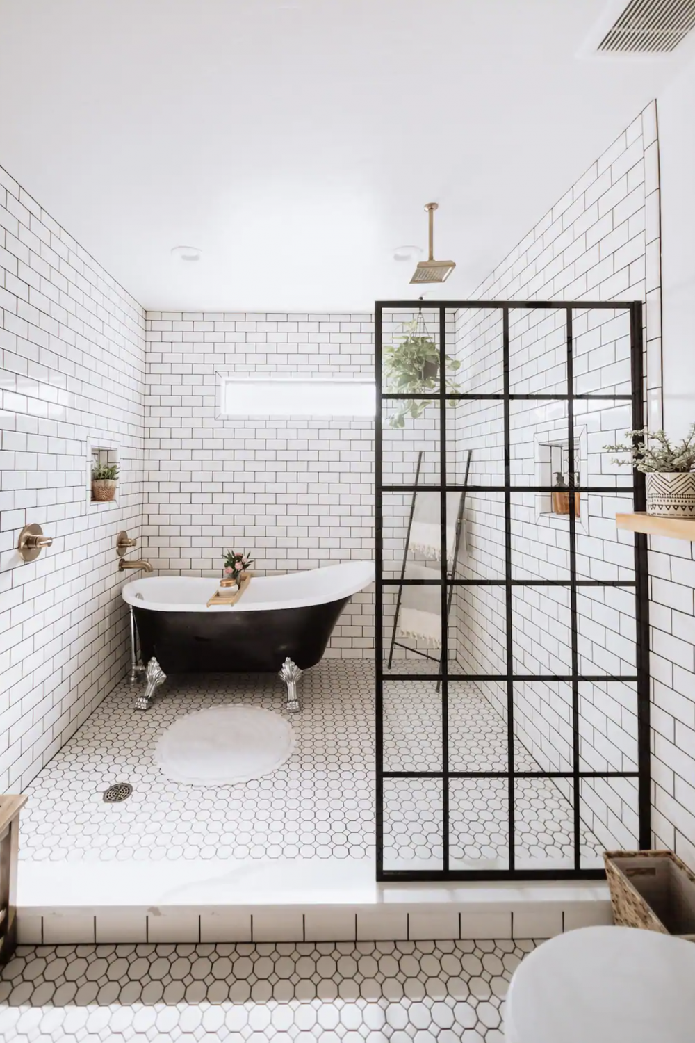 Classic bathroom with black clawfoot tub paired with luxurious accents.