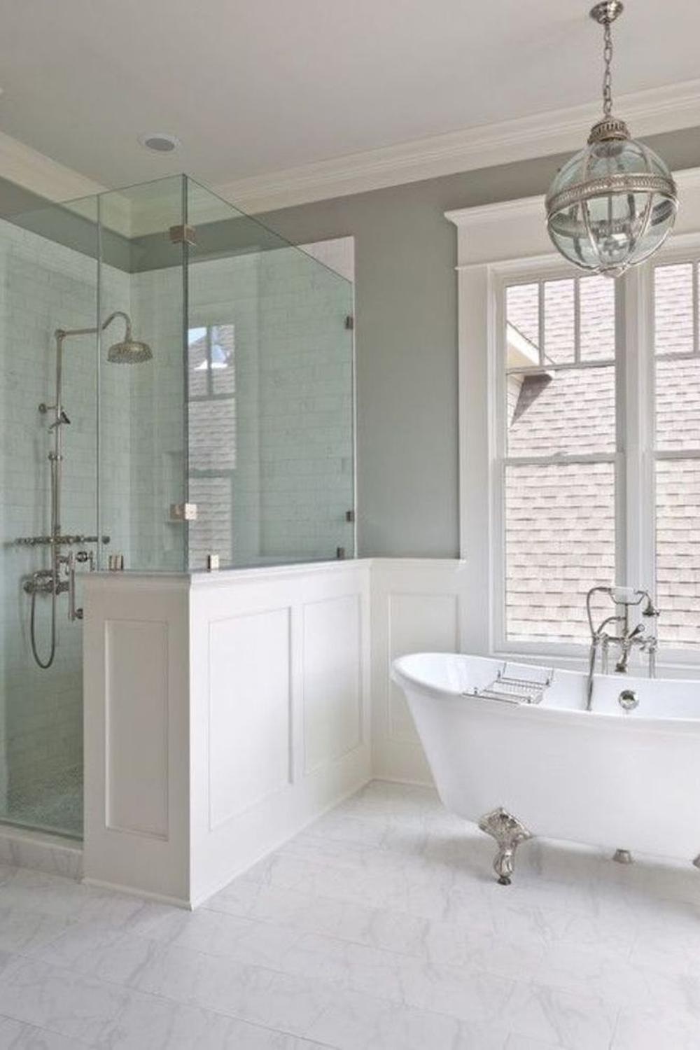 Stylish bathroom design featuring a striking clawfoot tub paired with glass-panelled shower.