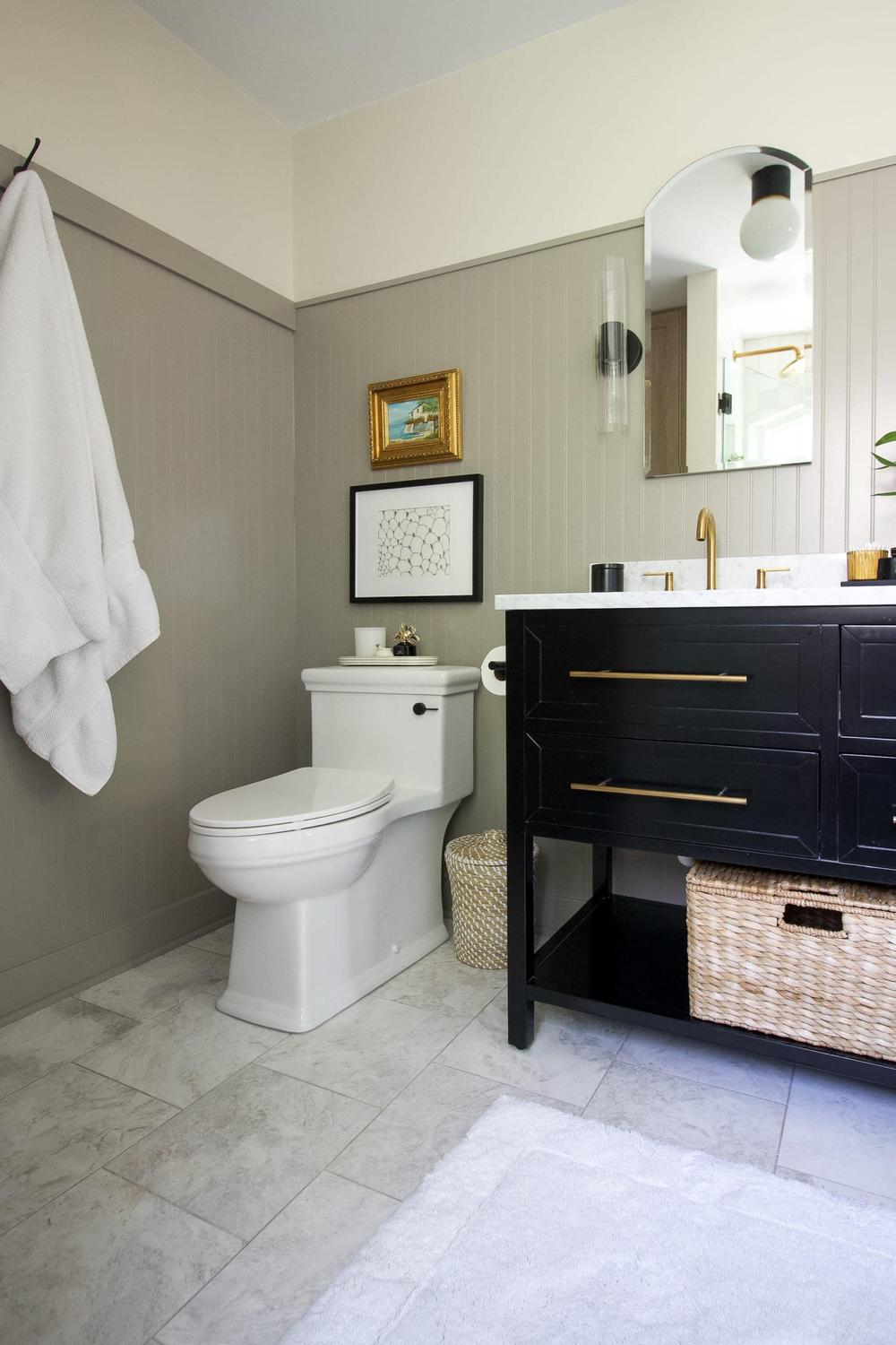 Modern bathroom featuring gray beadboard, contemporary fixtures, and elegant accessories