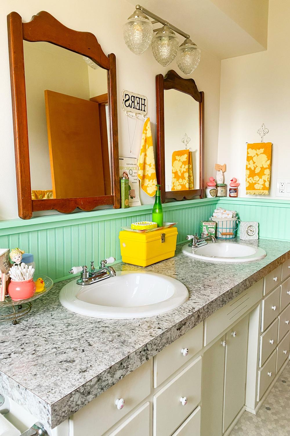 Charming bathroom featuring light green beadboard and vintage elements