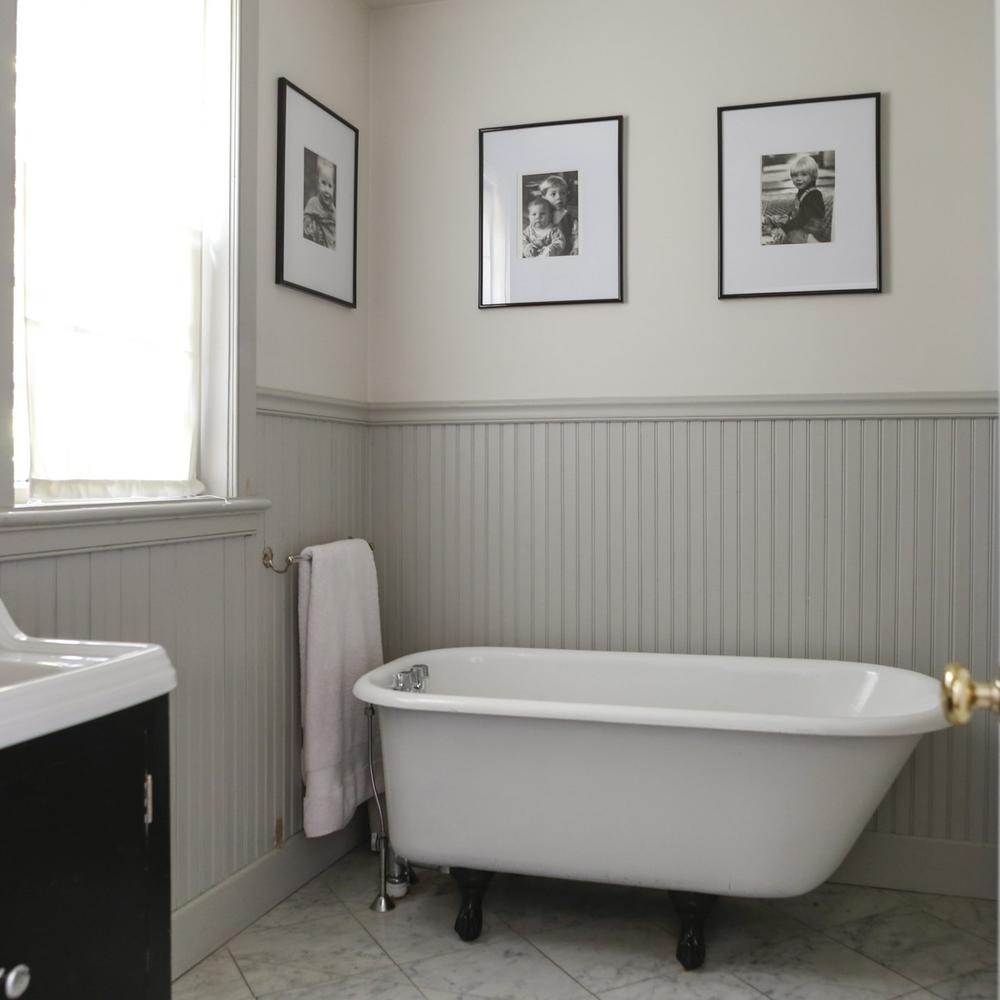 Stylish bathroom incorporating beadboard and artistic decor