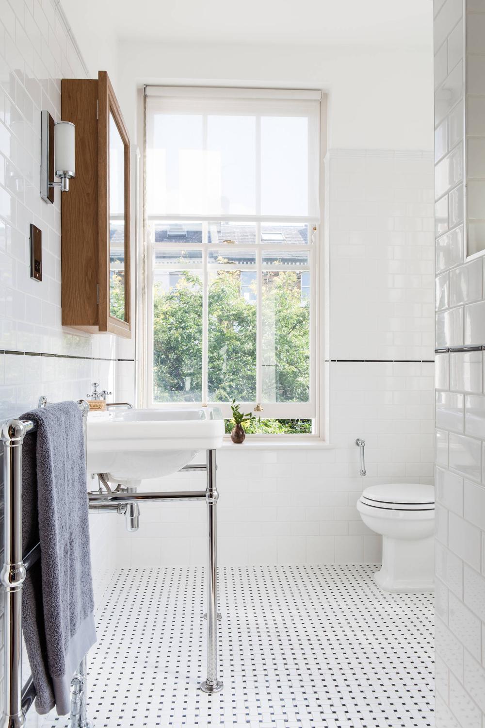 Modern bathroom featuring classic polka-dot tiling and elegant fixtures.