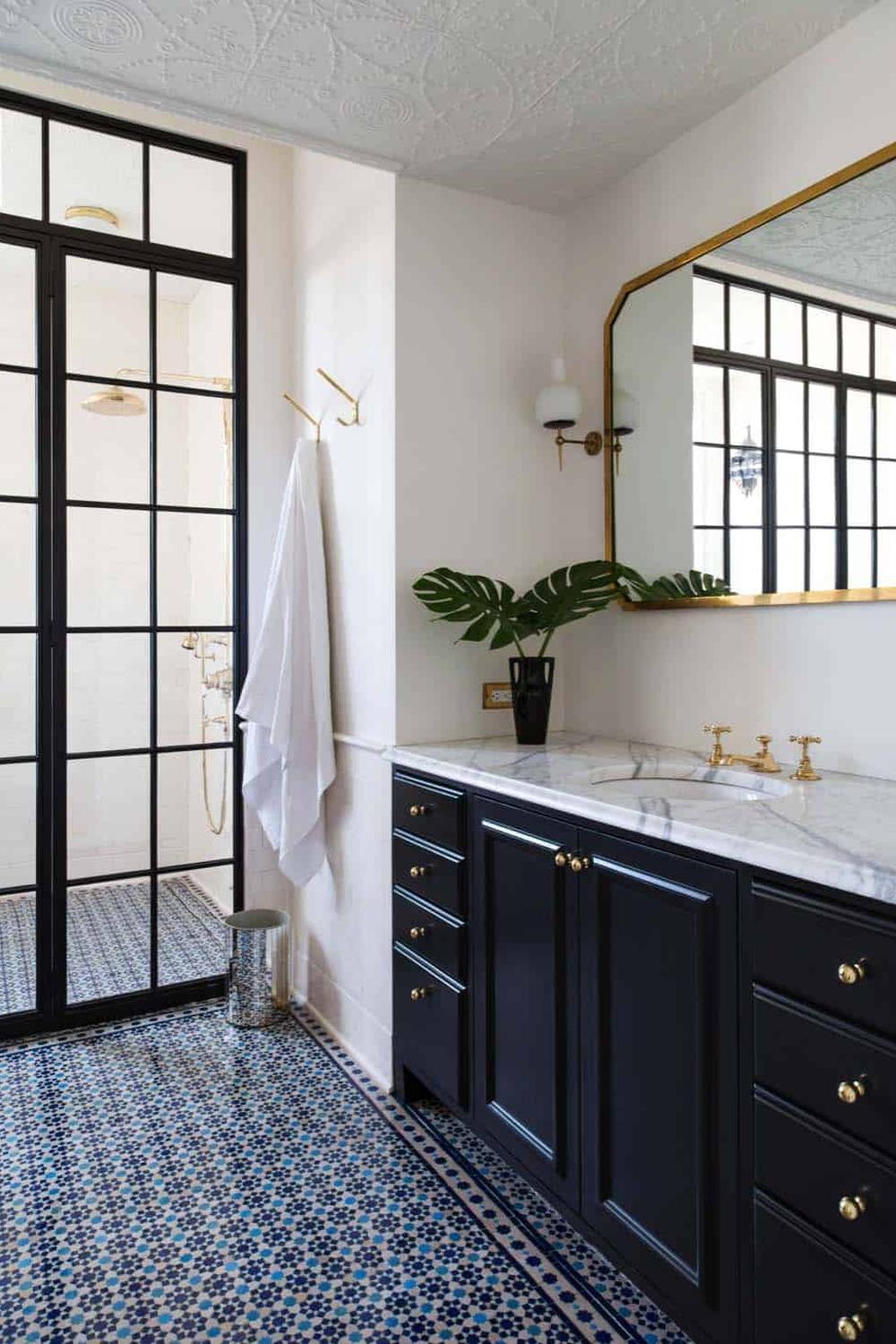 Stylish bathroom featuring dark navy blue accents with elegant tile detail.
