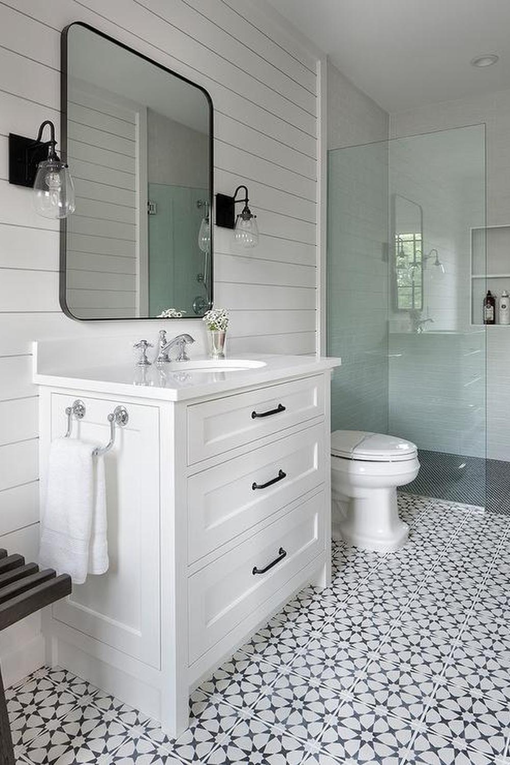 Modern bathroom featuring geometric black and white tiles and sleek fixtures.