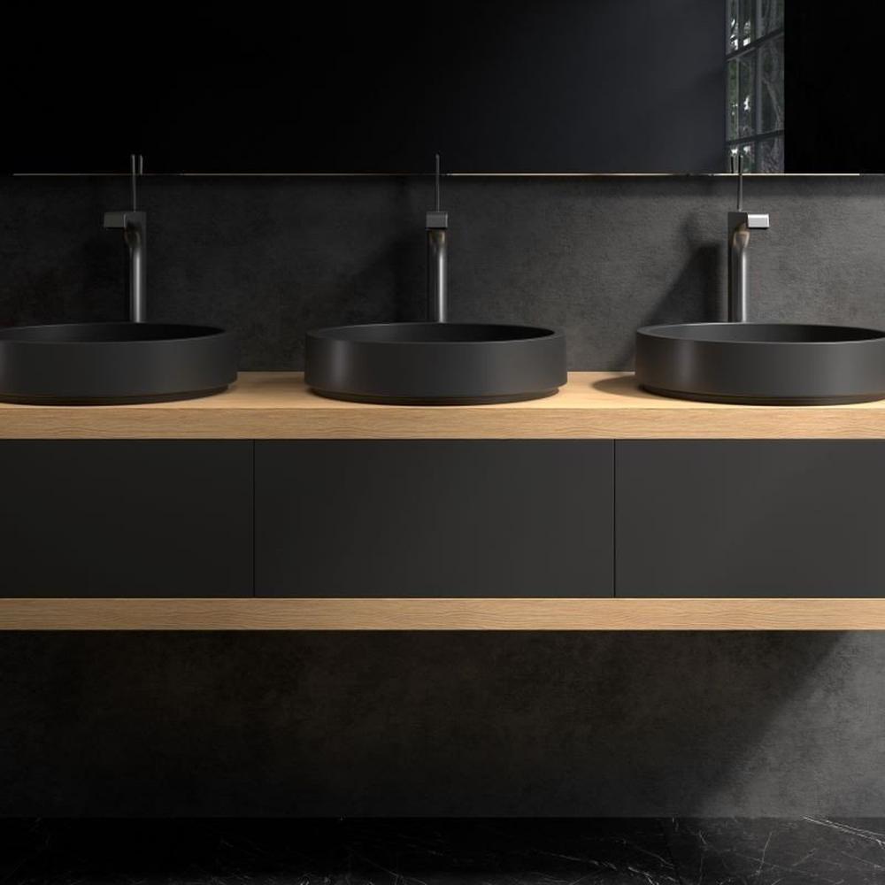 Stylish bathroom with dark cabinetry, light wood countertop, and black basins along with enhanced natural lighting.