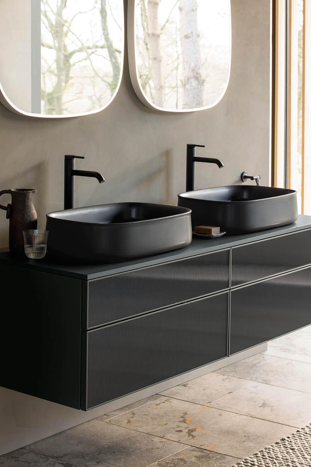 A stylish modern bathroom with round edges and natural light.
