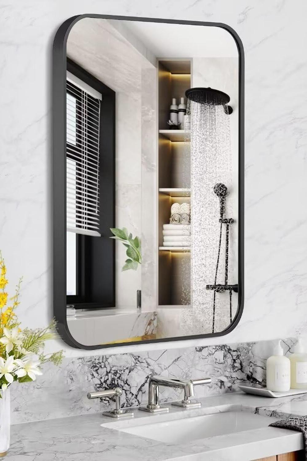 Modern bathroom featuring a rounded rectangular black mirror accentuating luxury.