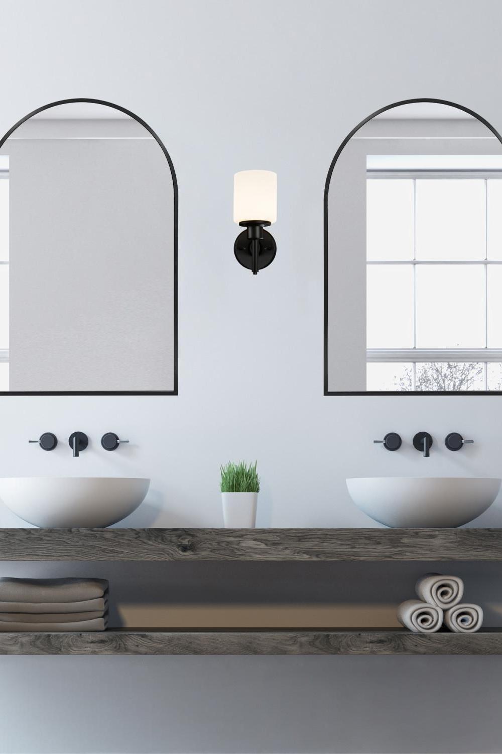 Modern oval mirrors bringing cheer to a bright contemporary bathroom.