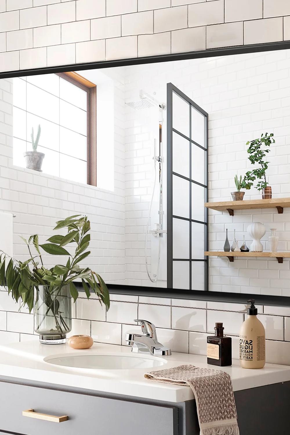 Distinct black framed bathroom mirror elevating a contemporary aesthetic.