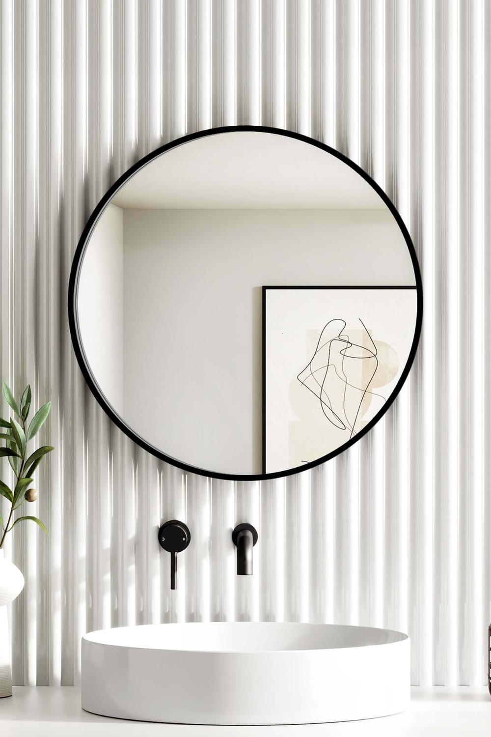 Contemporary circular black mirror enhancing a stylish bathroom design.