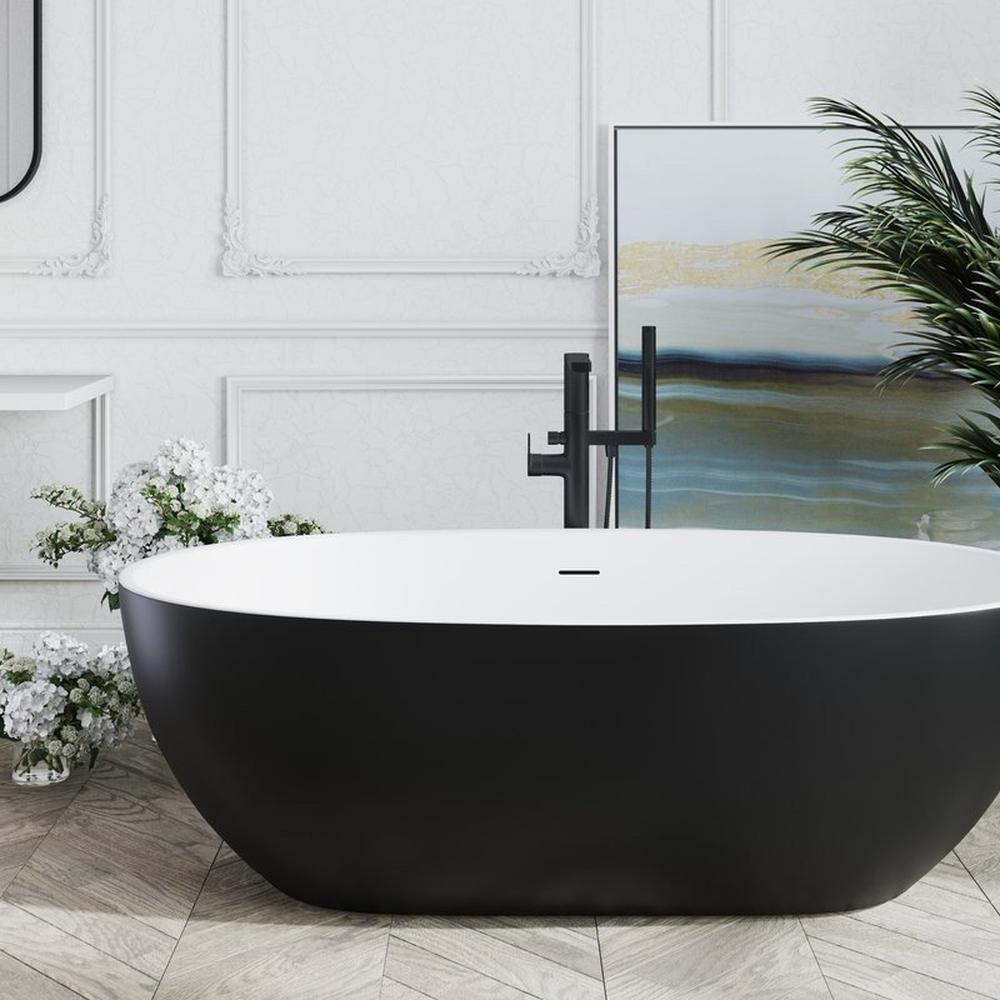 Contemporary bathroom with a black bathtub, textured walls, and modern artwork.