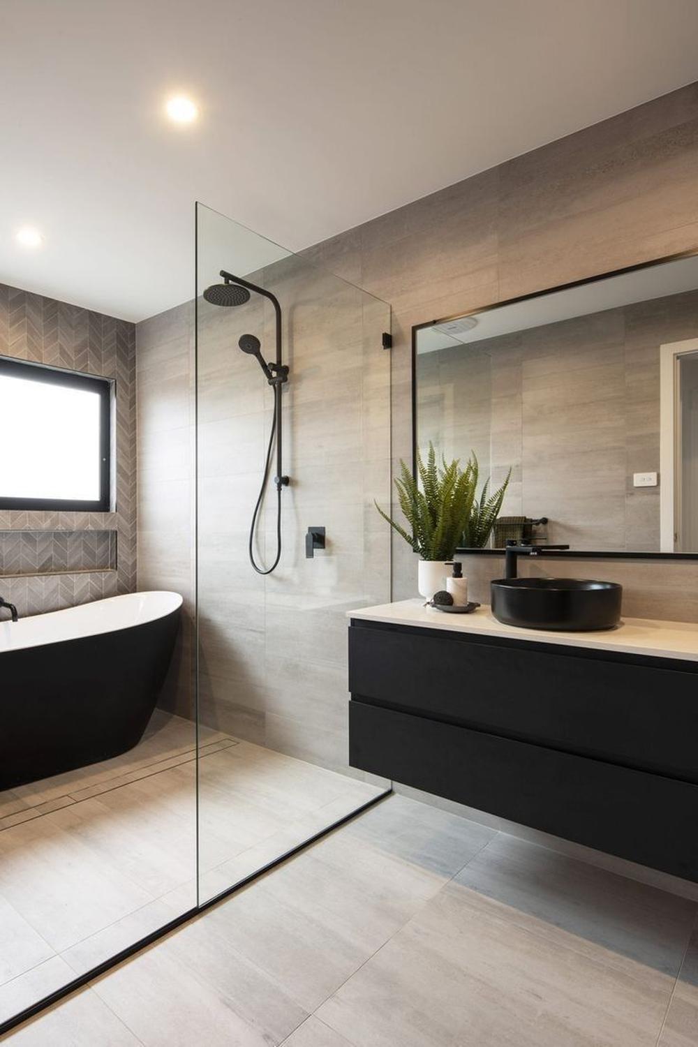 Modern bathroom design featuring a freestanding black bathtub and minimalist shower area.