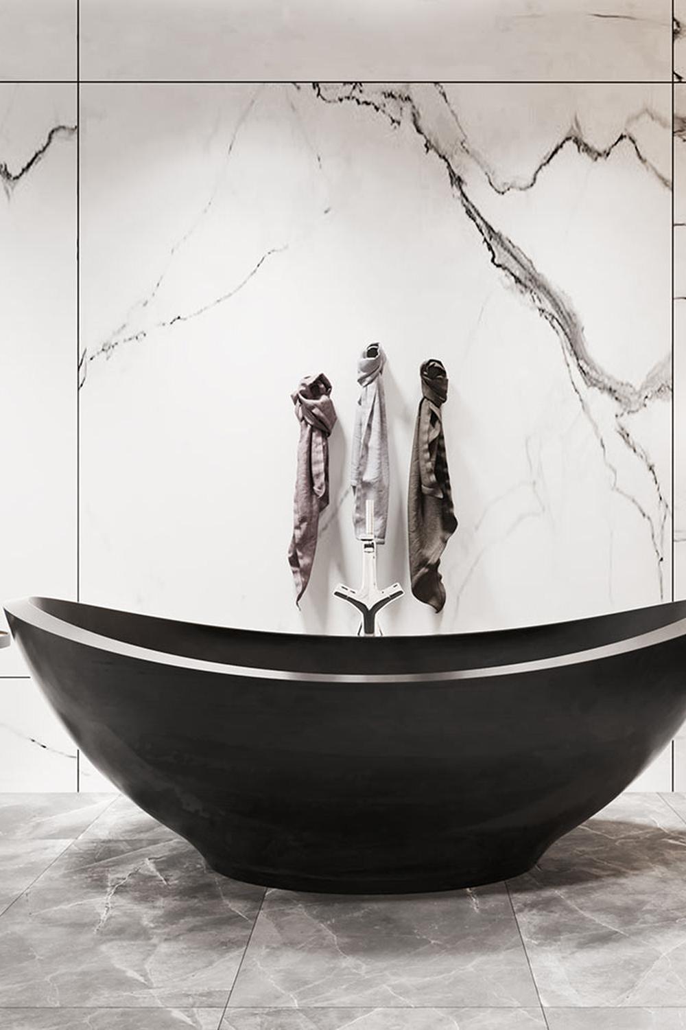 Luxury bathroom featuring an oval-shaped black bathtub and glossy marble walls.