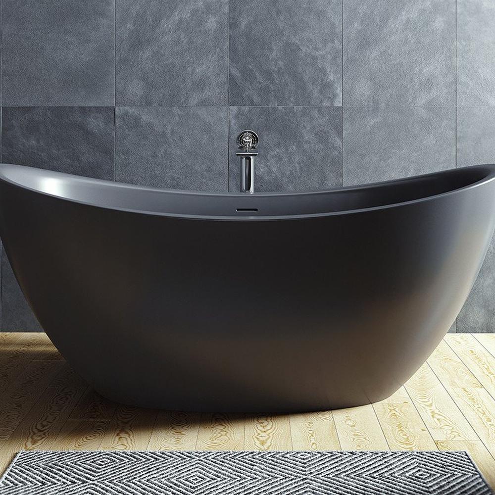 Modern bathroom featuring a freestanding black bathtub and stylish gray wall tiles.