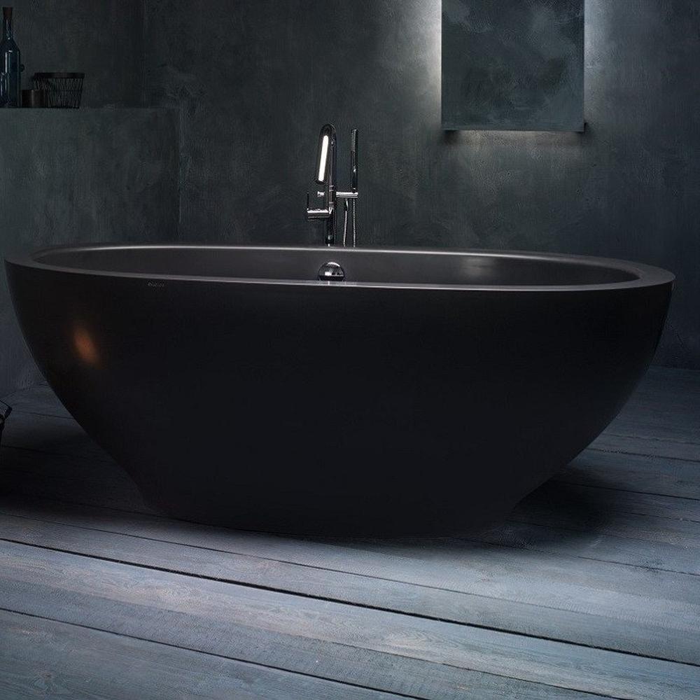 Stylish minimalist bathroom highlighting a sleek black bathtub with delicate decor.