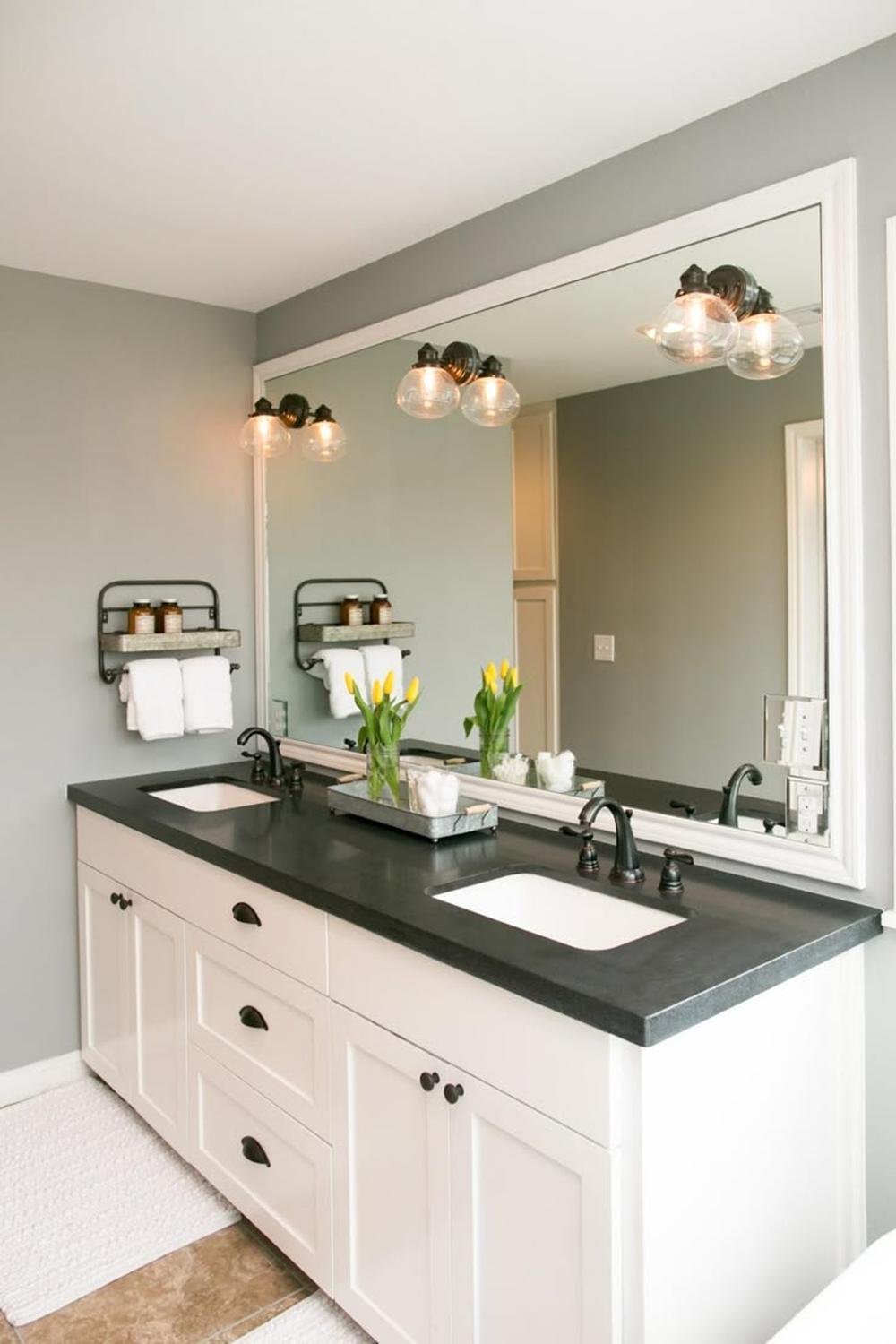 Inviting bathroom featuring smart storage solutions with a black countertop.