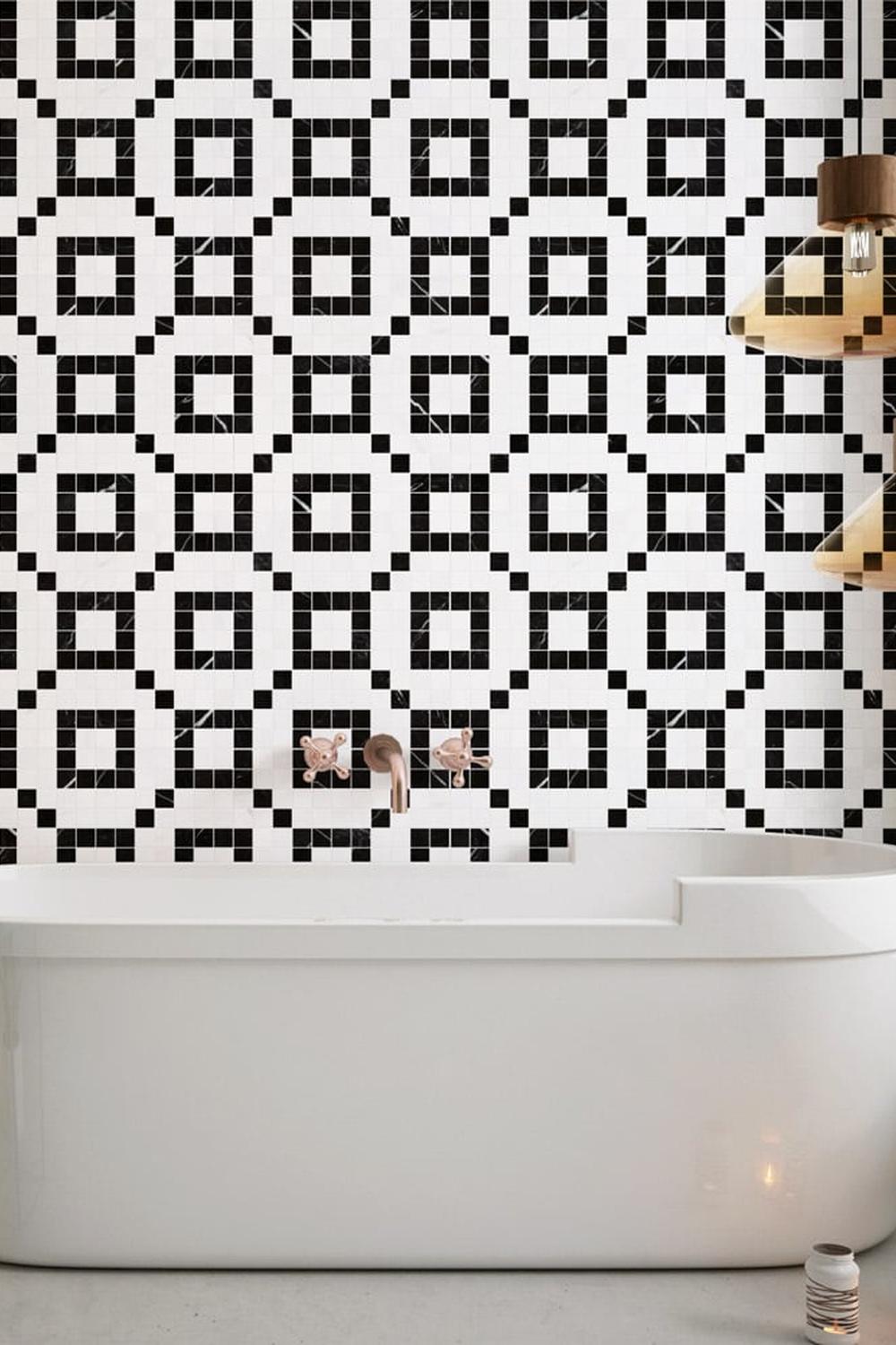 Modern bathroom featuring a classic tub with geometric mosaic wall tiles.