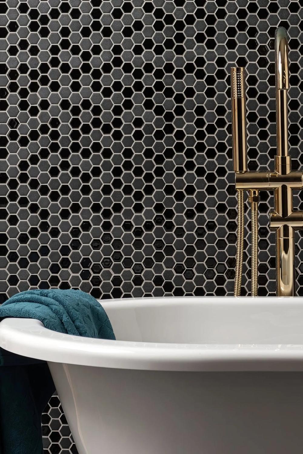 Laundry room featuring black hexagon tiles for effortless beauty.
