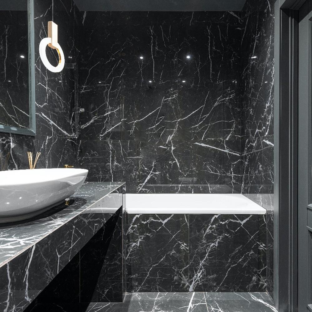 Baño con mármol negro y formas elegantes