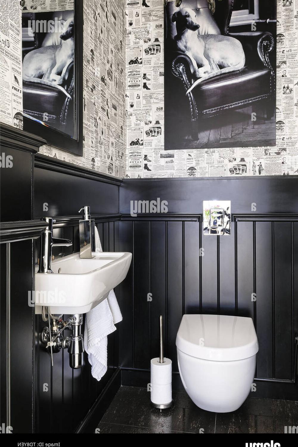 Stylish bathroom with black wallpaper and newspaper-style decor.