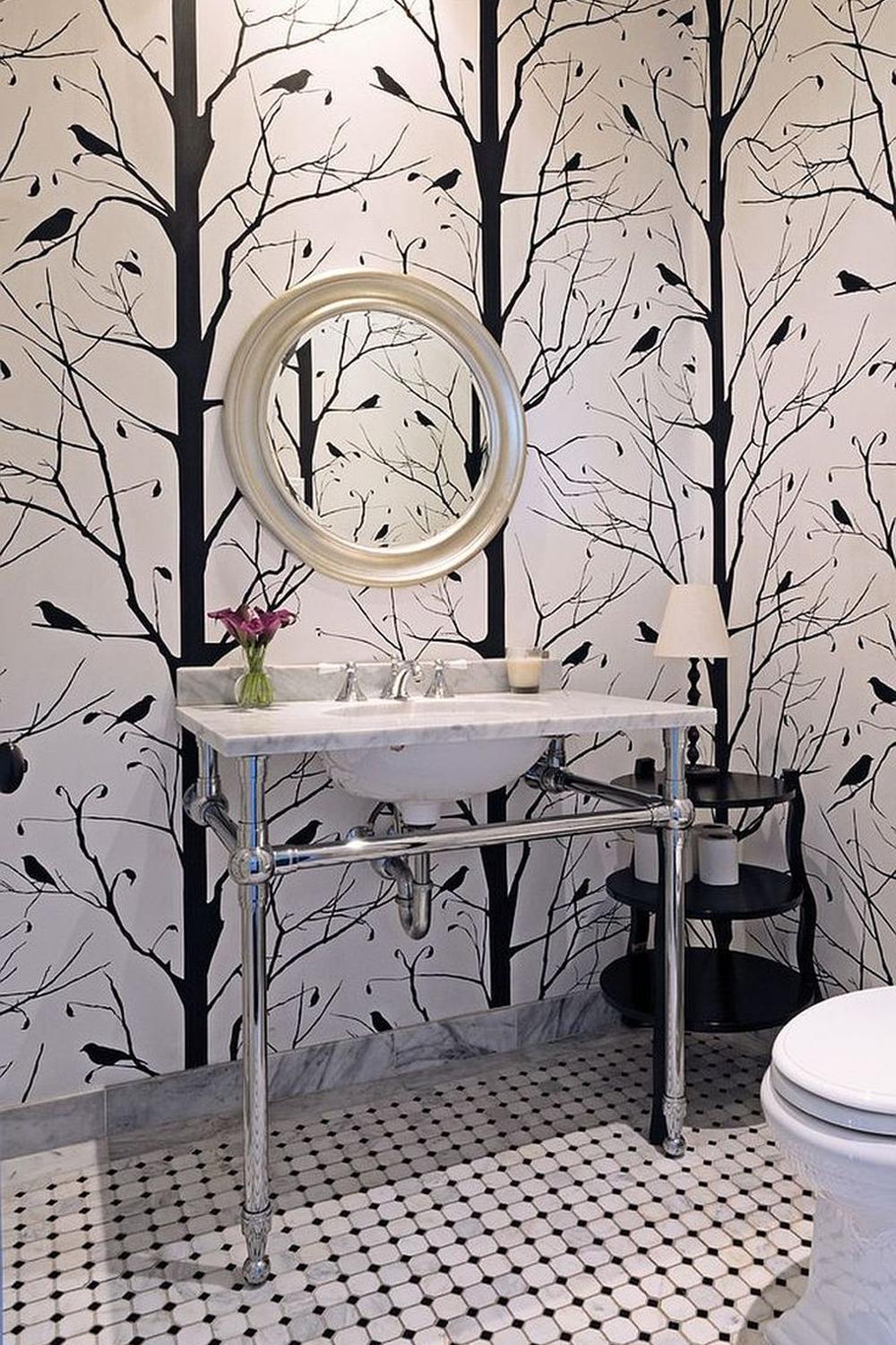 Stylish bathroom featuring a dramatic black wallpaper depicting bare trees.