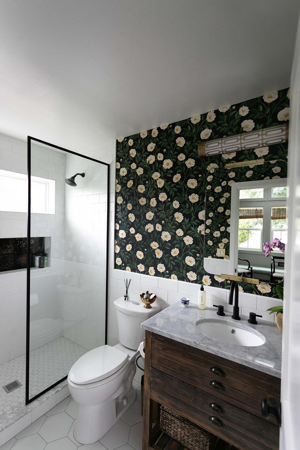 Stylish bathroom featuring a blend of black wallpaper and practical features.