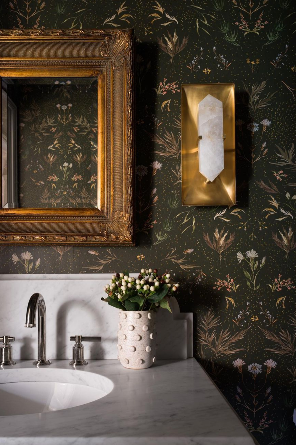 Stylish bathroom featuring black floral wallpaper with delicate patterns.