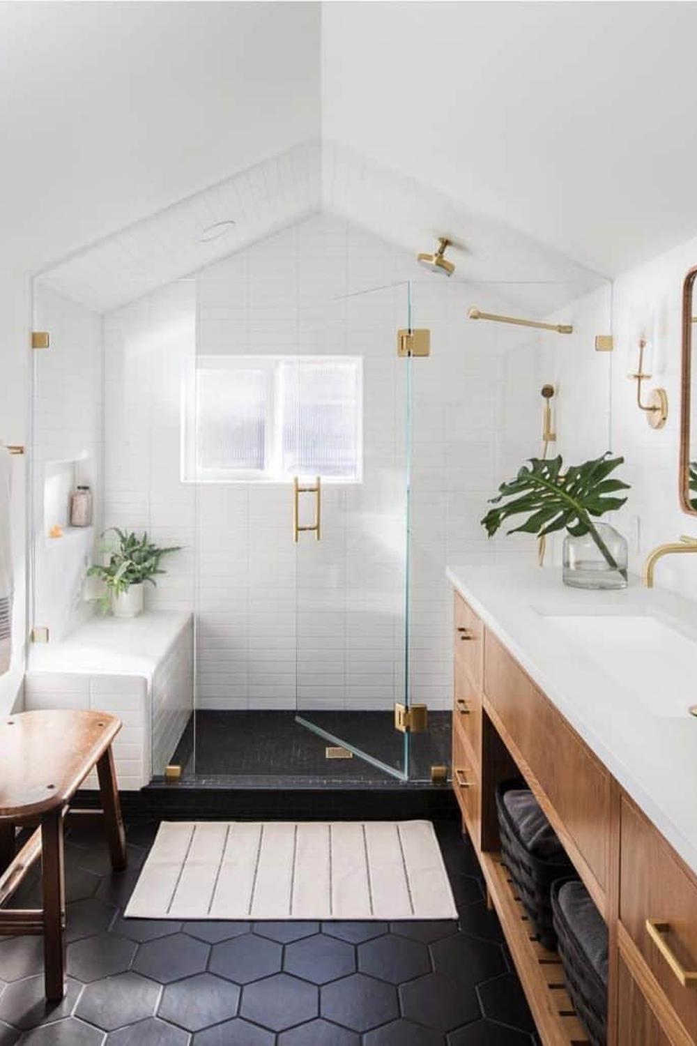 A minimalist black and white bathroom with gold accents.