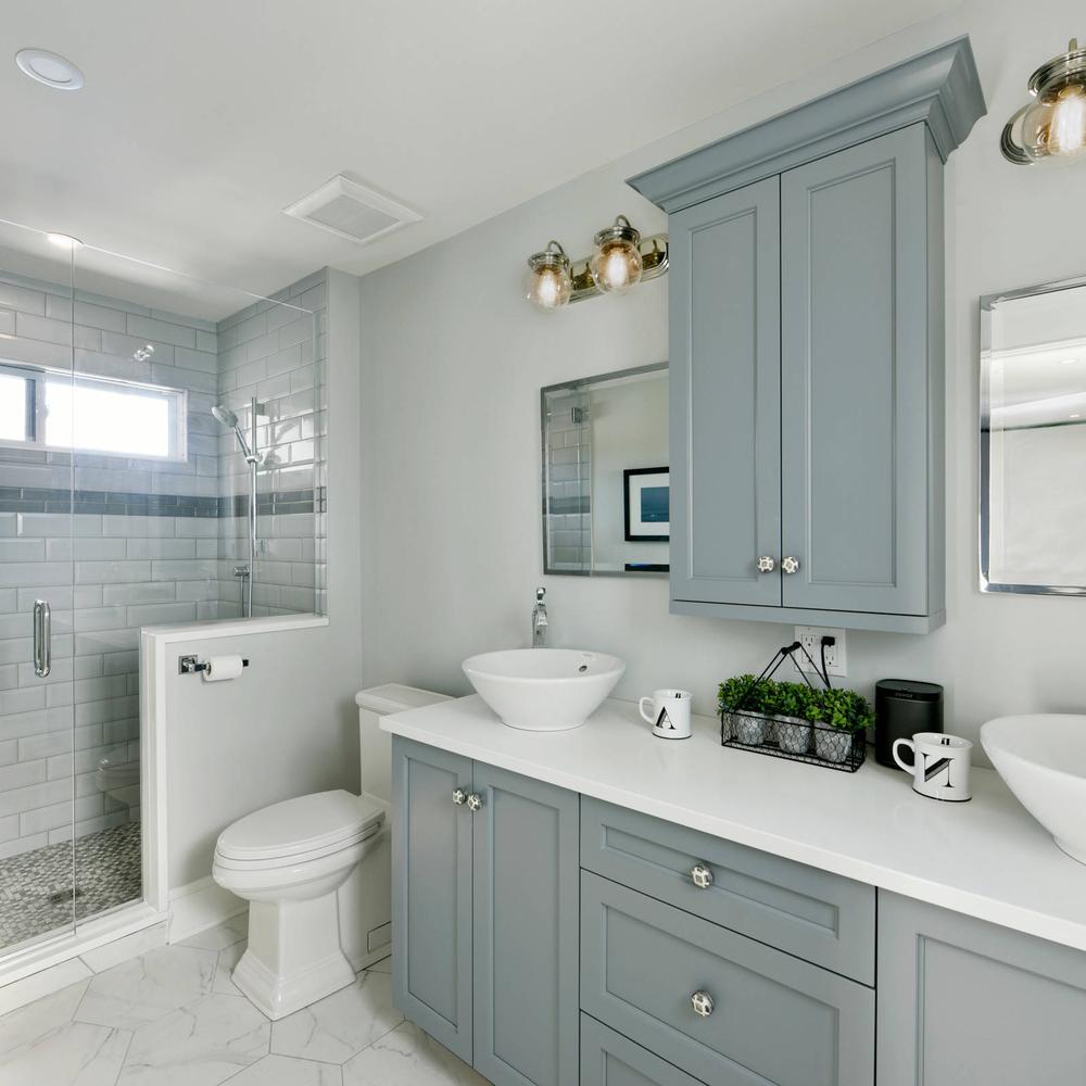 Minimalist dual vanities in gray and blue bathroom