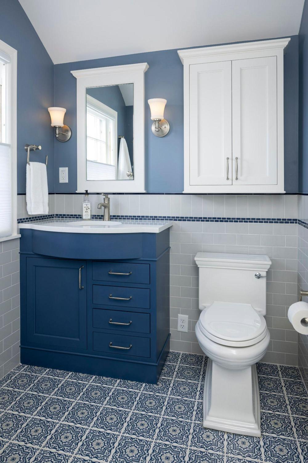A modern bathroom featuring a striking navy blue vanity