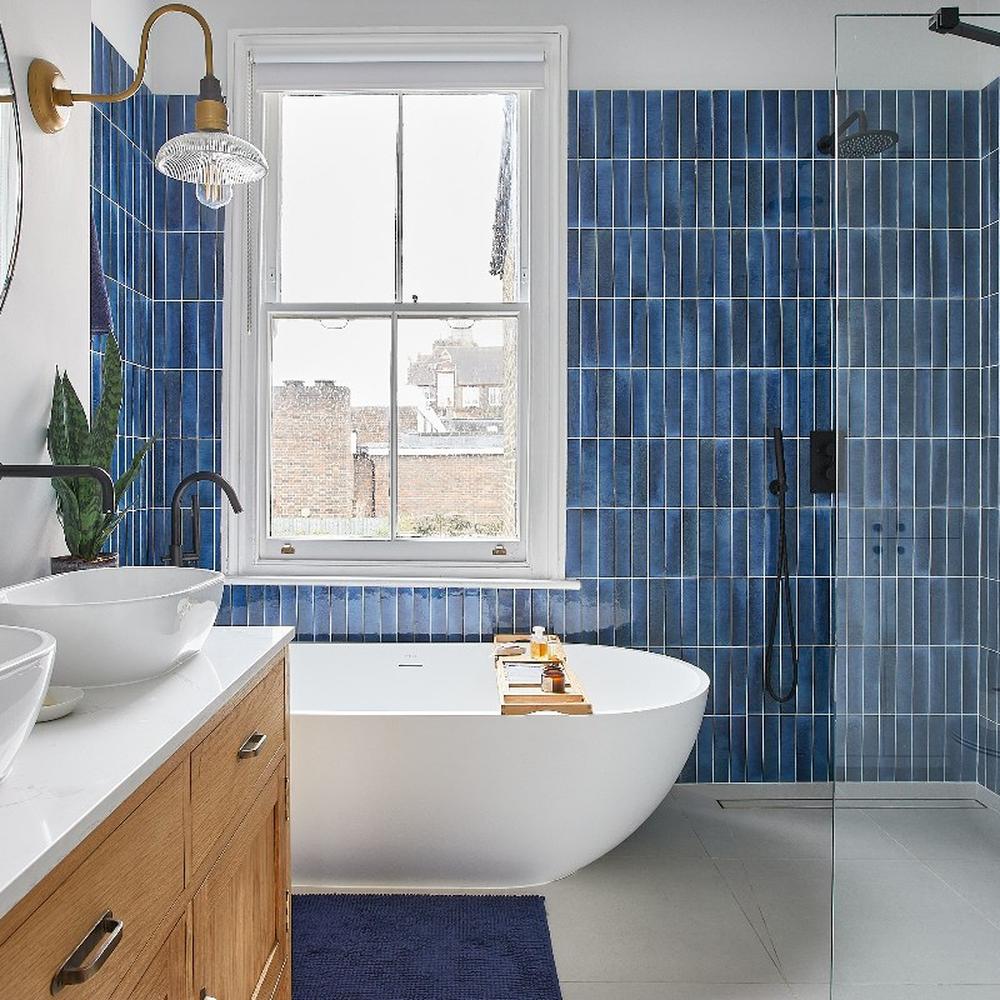 A stylish bathroom with vertical blue tiles creating a refreshing atmosphere
