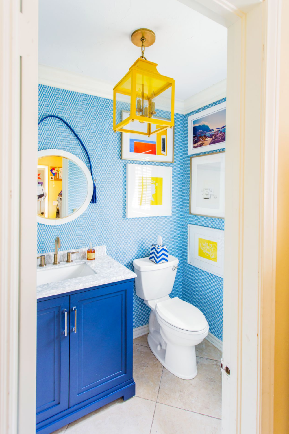 A bright bathroom with cheerful blue and yellow accents