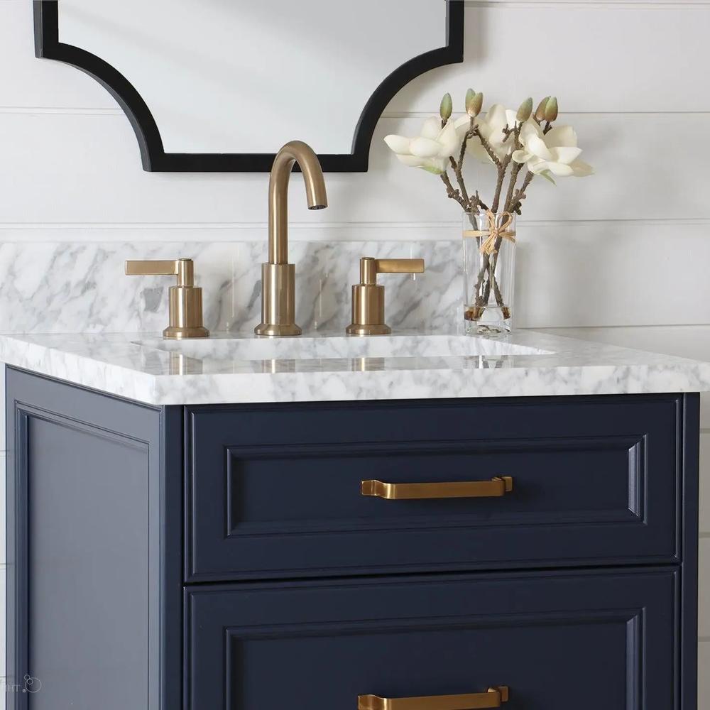 Rustic blue vanity with modern elements and natural floral arrangements.