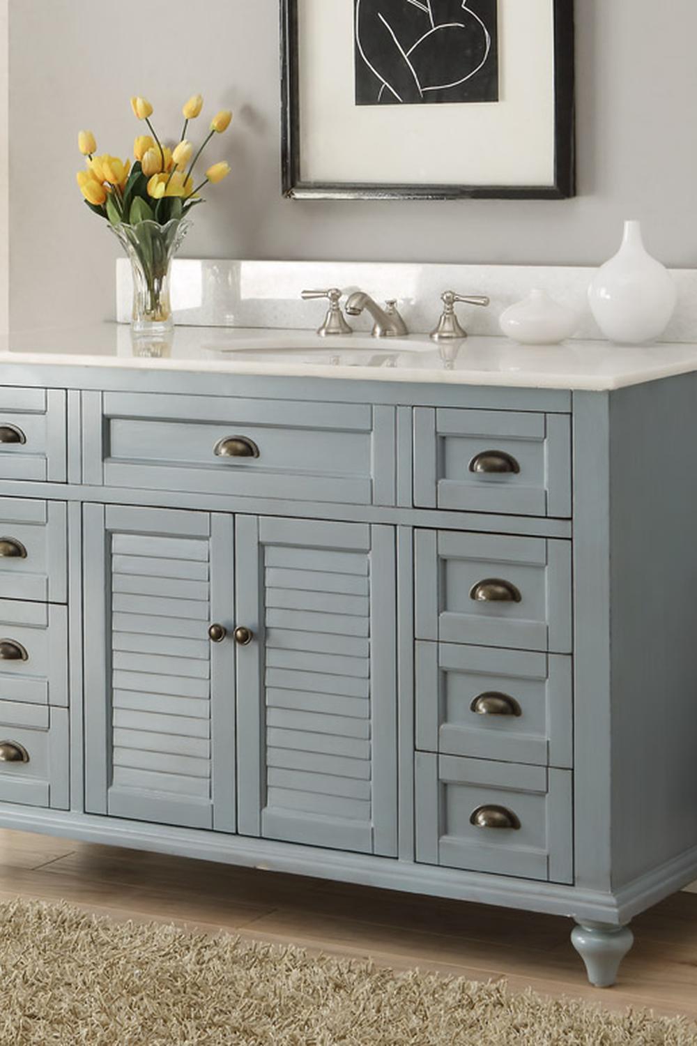Contemporary blue vanity with luxurious accents and elegant fixtures.