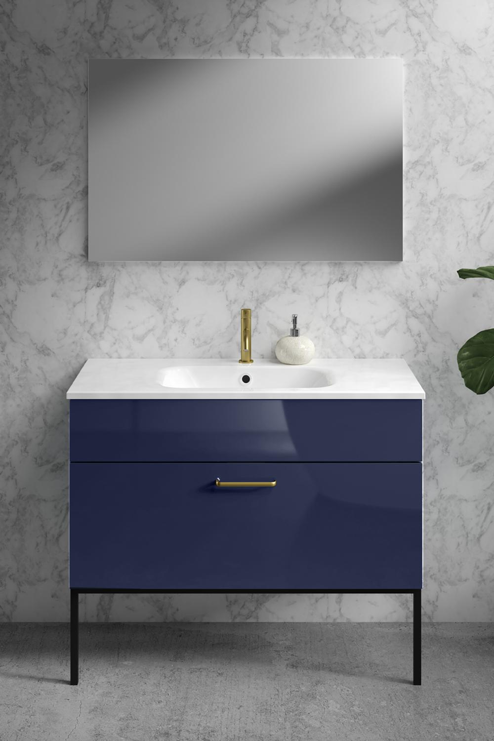 Luxuriously sleek blue vanity paired with modern fixtures and design elements.