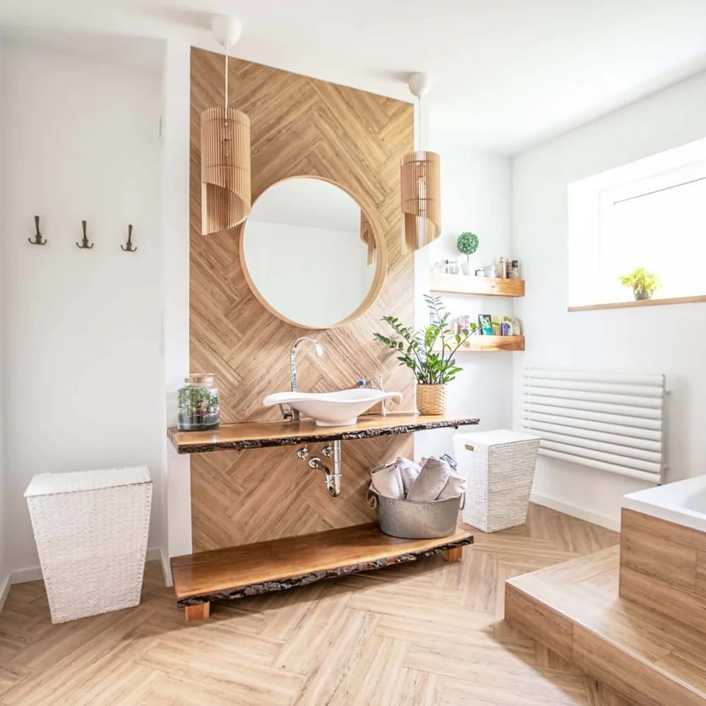 A minimalist bohemian bathroom featuring a wood accent wall and sculptural sink.