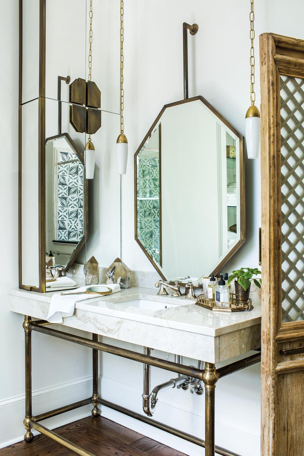 A stylish bohemian bathroom featuring double sinks and warm finishes.