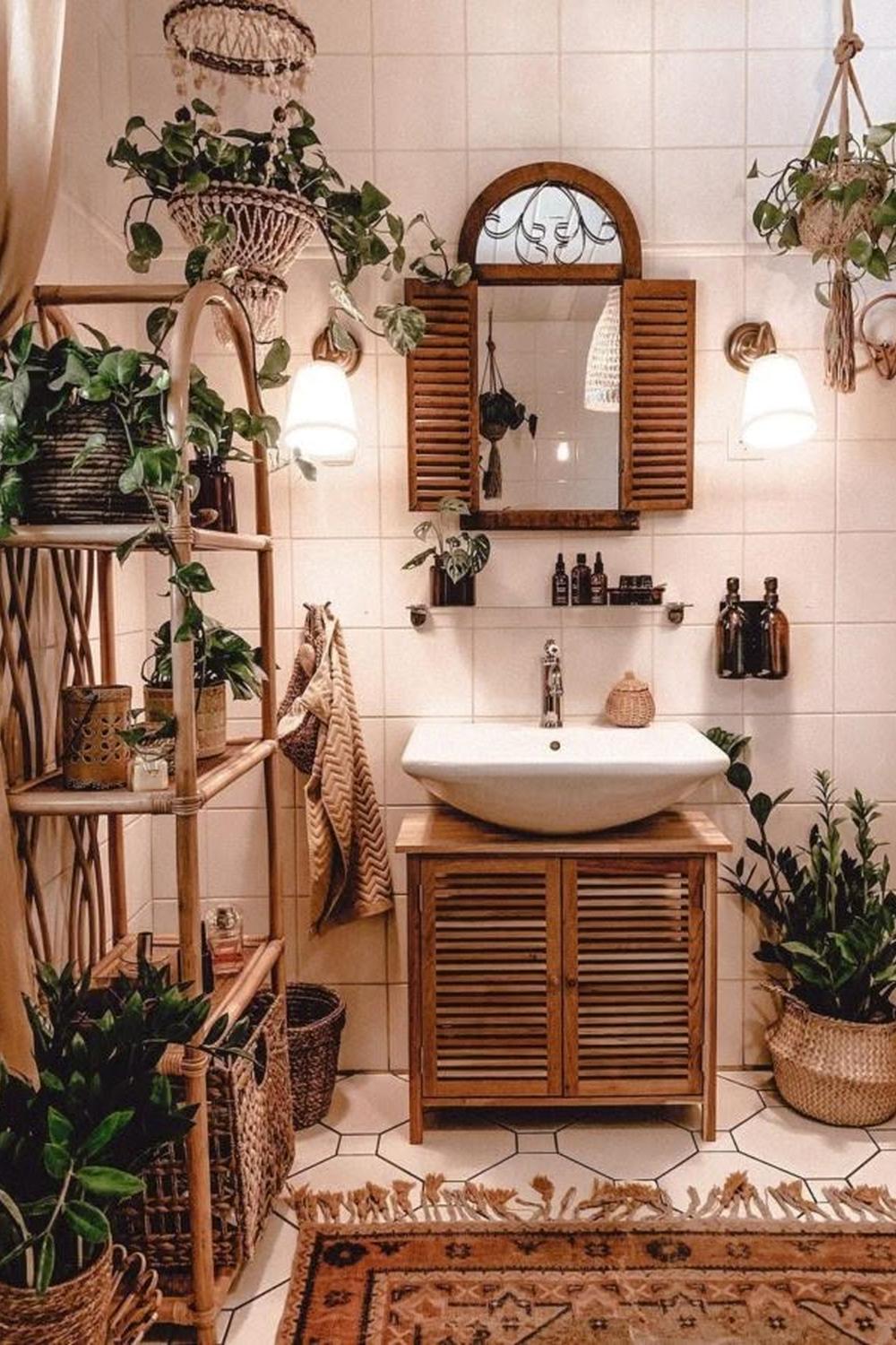 A bohemian bathroom with a wooden vanity and a vintage-style mirror.