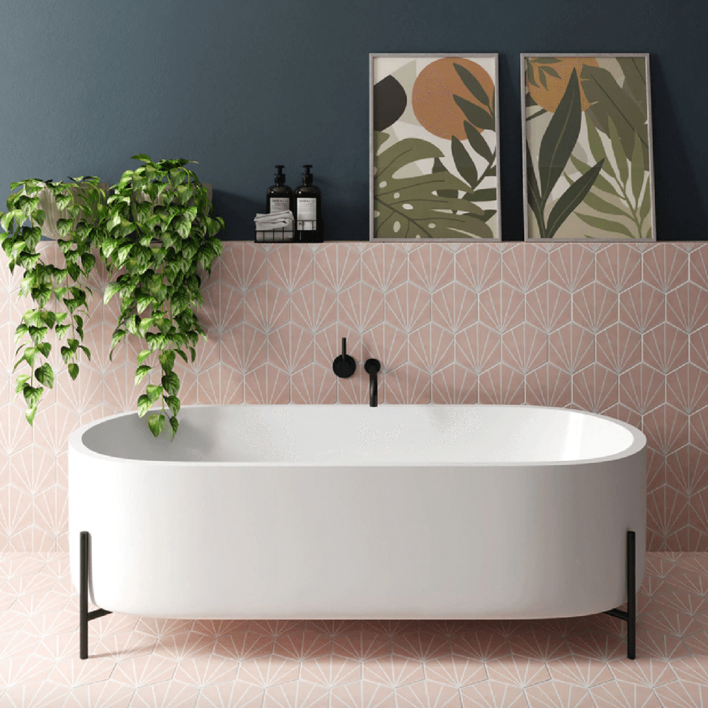 Stylish bohemian bathroom with geometric pink wall tiles and vintage style bathtub.